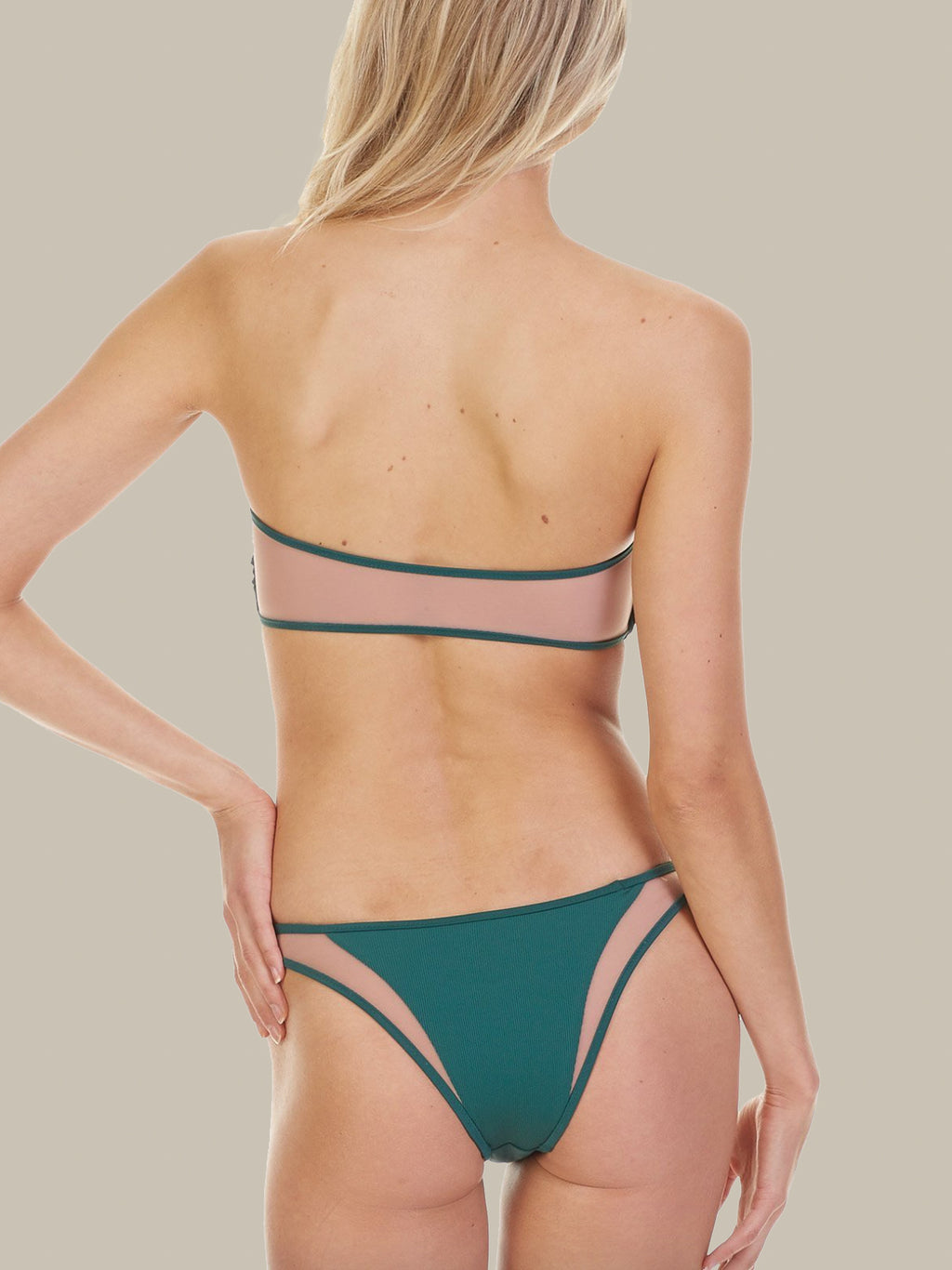 The Manon Bottoms are emerald green and feature mesh detail. These bikini bottoms also have minimal coverage and pair perfectly with the Royale Top.