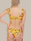 The back of the Raven Top is also bright yellow with a floral print. The back of the bikini top has a scoop back and non-adjustable straps.